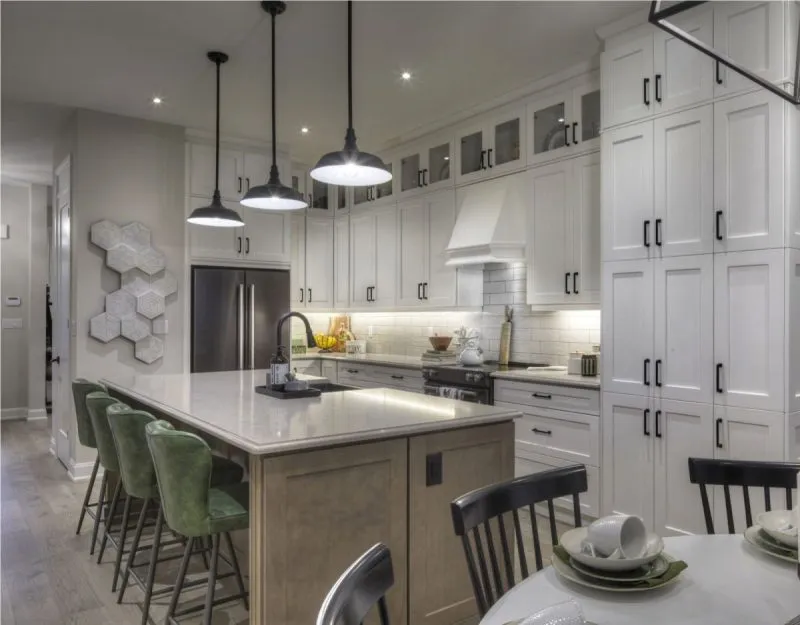 Kitchen with a quartz island and shaker cabinetry in an Upper Joshua Creek model home